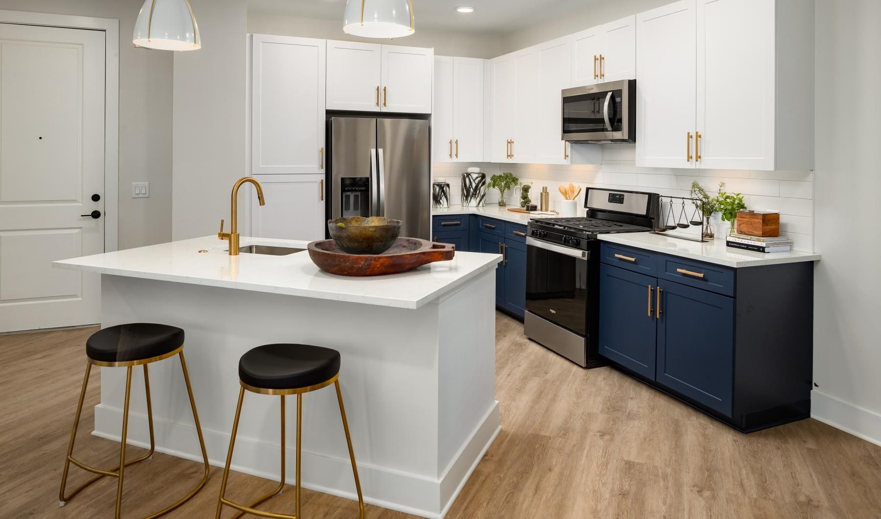a kitchen with a table and stools