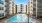 a pool in a courtyard between buildings