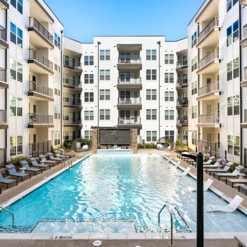 Shimmering resort-style pool a pool in a courtyard between buildings