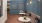 a living room with a bench seat couch and tables