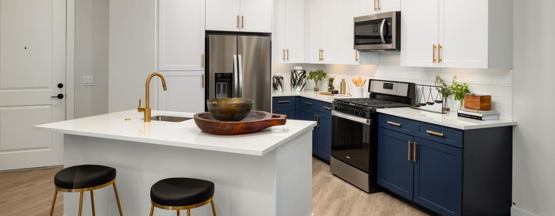 a kitchen with a table and stools
