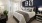 a bedroom with a bed and a fan