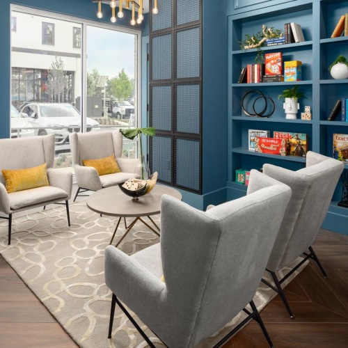 All the comforts of luxury living a room with a table chairs